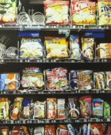 A vending machine with many colored products ready to be selected