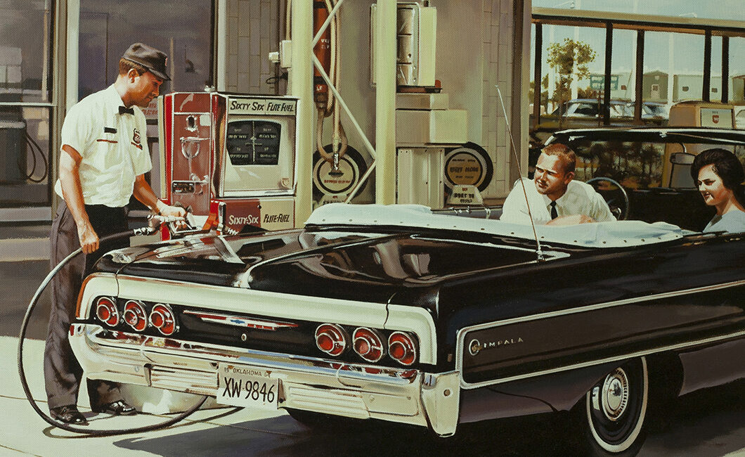 Two people on an Impala XW refuelling at a gas station