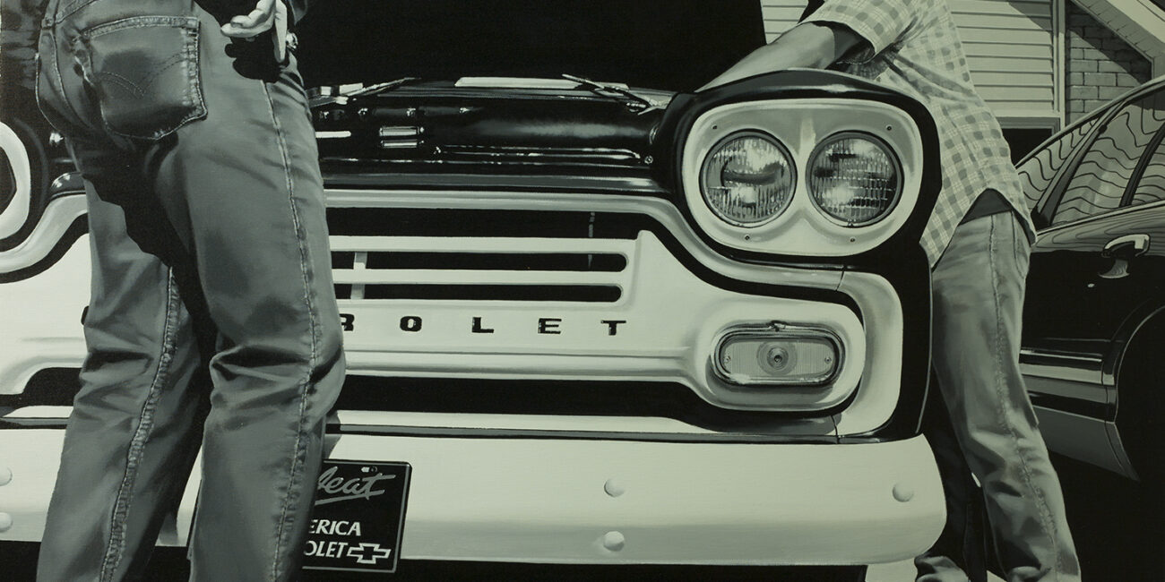 Two men repairing a Chevrolet engine
