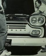 Two men repairing a Chevrolet engine