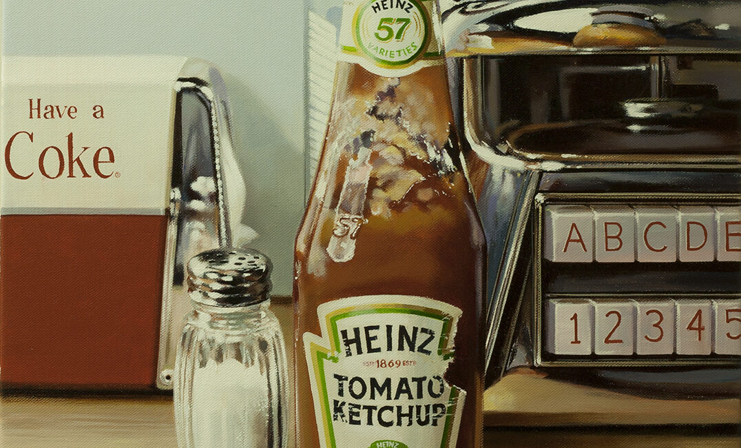 A ketchup bottle dispenser on a set table
