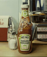 A ketchup bottle dispenser on a set table