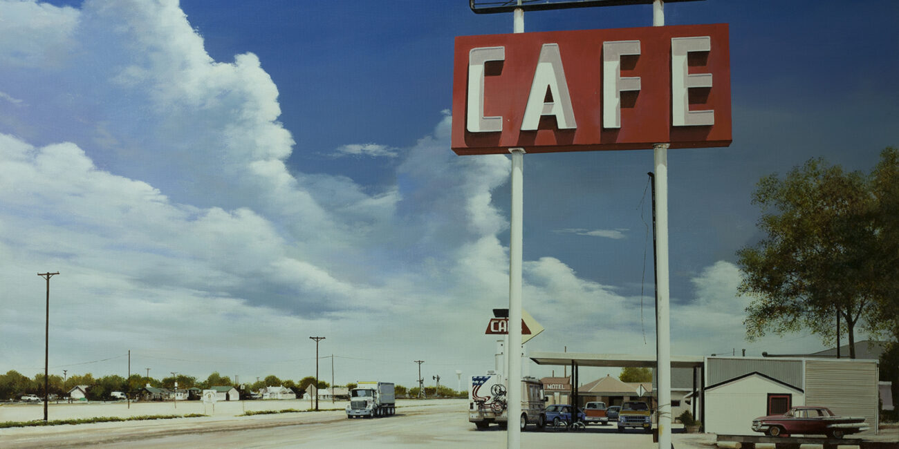 Some cars and a red pick-up in front of a Motel in the USA